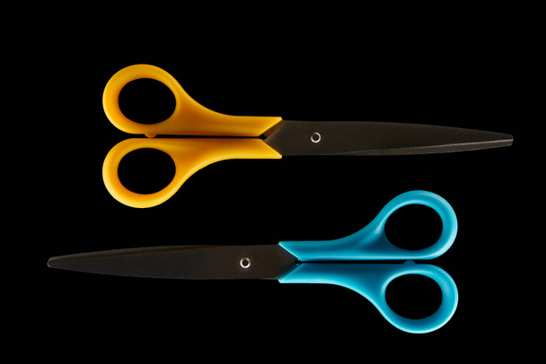 top view two closed scissors isolated on black  - Photo, Image