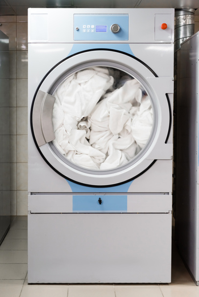 white bed sheets in electric washing machine in laundry in hotel  - Photo, Image