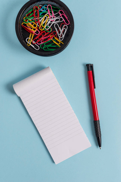 Notizbuch und Schreibgeräte mit Computerwerkzeug vor pastellfarbenem Hintergrund. Papier plus Schreibwaren kleben ebenfalls an einem modernen Hintergrund. künstlerische Art der flachen Lagen-Fotografie - Foto, Bild
