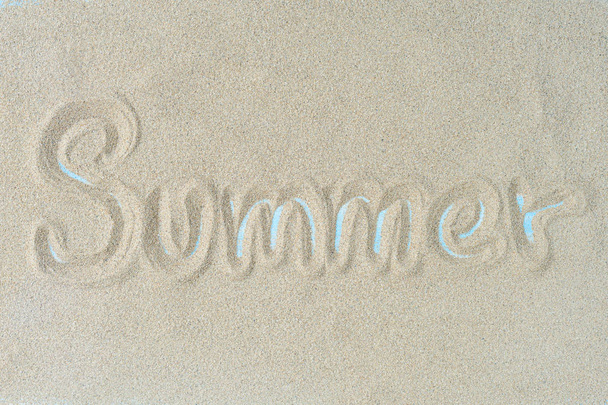 The word summer is writting on the sand. Summer background. - Fotoğraf, Görsel