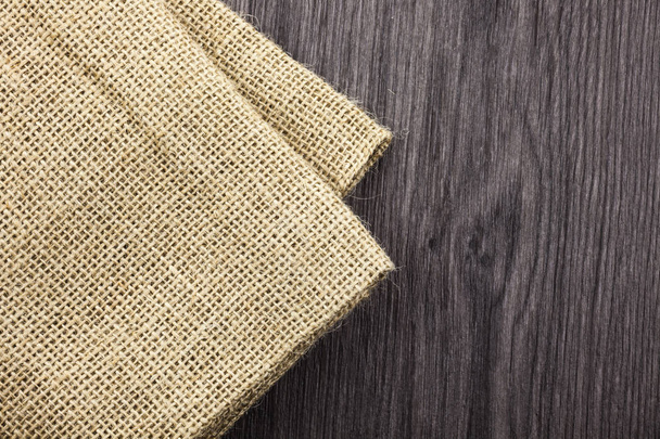 Front view wooden background blank textile, jute, linen, tag, piece isolated on colored timber back. Abstract design. Back timber fabric design. Banner - Photo, Image