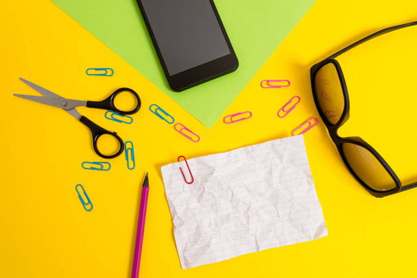 Front view colored blank paper sheets clips pencil smartphone scissors eyeglasses color background. Empty text important future events. What to do home school office - Valokuva, kuva