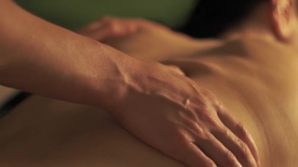 Concept of massage. Beautiful young woman gets a relaxing massage - Felvétel, videó