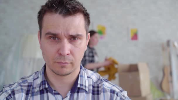 unhappy mans face during the divorce ,in the background of the box to move - Metraje, vídeo