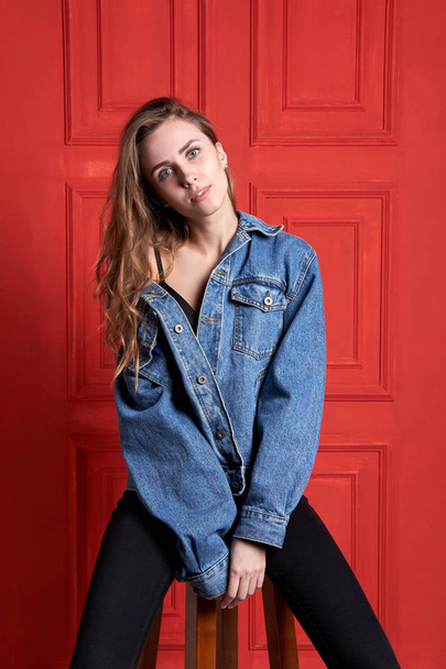 Young attractive girl or model with long hair dressed in a denim - Photo, Image