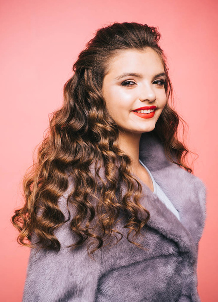 Boosting heavy curls volume. Teenage girl with stylish wavy hairstyle. Young woman with long locks of hair. Pretty girl with curly hairstyle. Healthy hair care habits. Hair styling in beauty salon - Foto, immagini