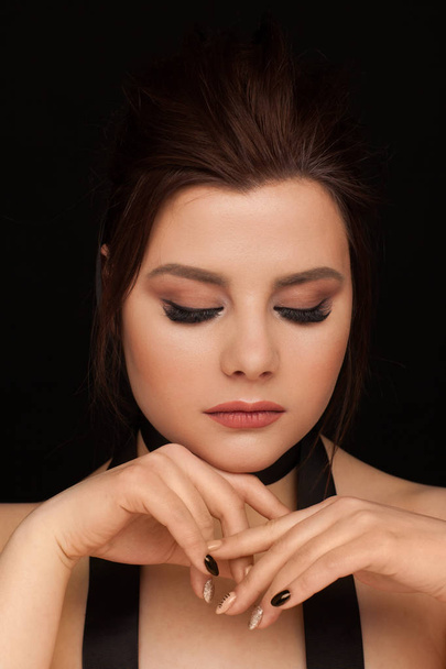 Dramatic portrait of a brunette with black ribbon. Studio photo session - Fotó, kép