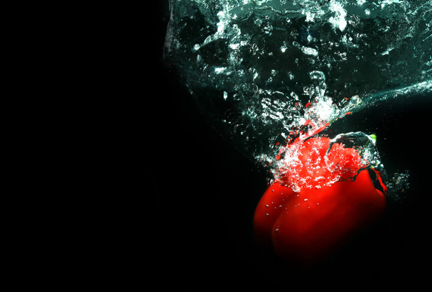Red pepper in black water - Photo, Image
