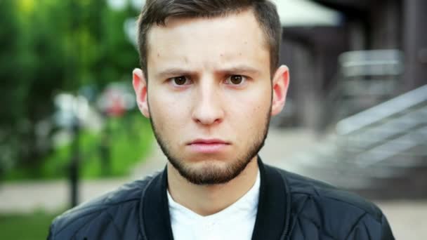Man has a angry look on his face. Portrait of man frowning with an displeased face - Footage, Video