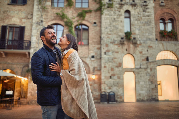 Romantic couple embracing and walking around old town on vacatio - Valokuva, kuva