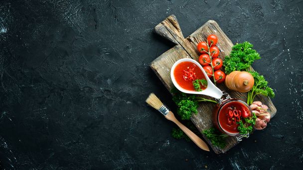 Barbecue sauce. Tomatoes, spices and herbs. Top view. Free space for your text. - Photo, image