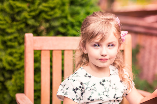 Charming little girl in a beautiful dress outdoor - Fotografie, Obrázek