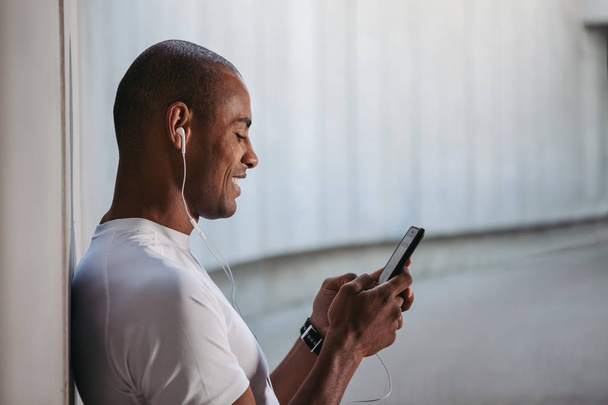 Man checking a playlist before training. - Photo, Image
