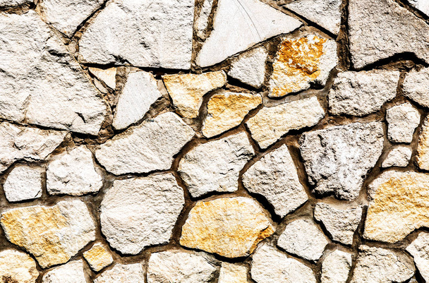 Verweerde stenen muur als achtergrond textuur - Foto, afbeelding