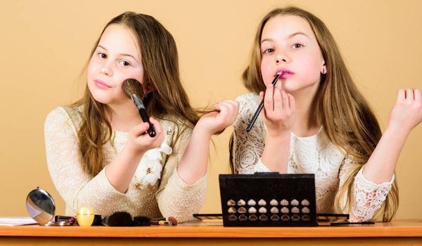 Makeup store. Experimenting with style. Makeup art. Explore cosmetics bag concept. Salon and beauty treatment. Just like playing with makeup. Makeup courses. Children little girls choose cosmetics - Fotoğraf, Görsel