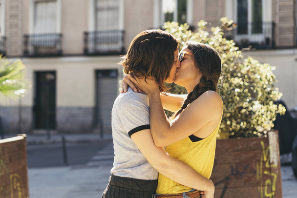 A couple of lesbian women kissing on a Madrid street. Same sex relationship concept. - Photo, Image