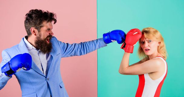 Couple in love competing in boxing. Female and male boxers fighting in gloves. Domination concept. Gender battle. Gender equal rights. Gender equality. Man formal suit and athletic woman boxing fight - Photo, Image