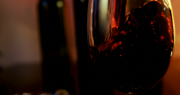 Close-up of red wine poured in wine glass. Bubbles in a glass. 4k - Video