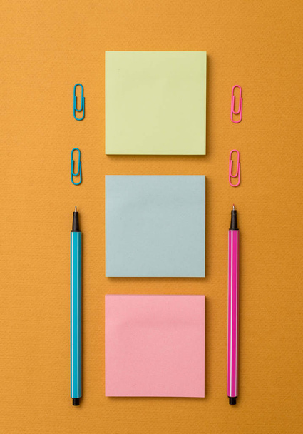 Front view blank sticky note two ballpoints pens clips trendy pastel cool background. Empty text future important events. What to do reminder office home school - Photo, Image