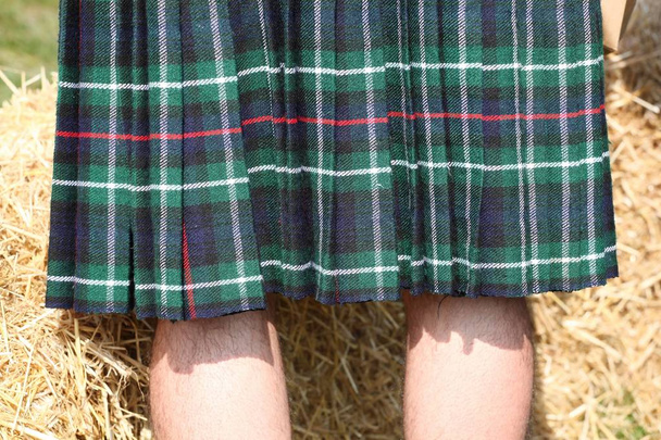 Legs of a man in Scottish green kilt  - Φωτογραφία, εικόνα