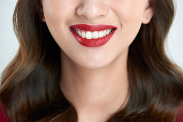 Female lips closeup. Beautiful smile of young fresh woman. - 写真・画像