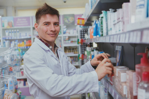 Beau pharmacien masculin travaillant dans sa pharmacie
 - Photo, image