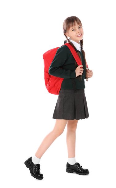 Full length portrait of cute girl in school uniform with backpack on white background - Foto, imagen