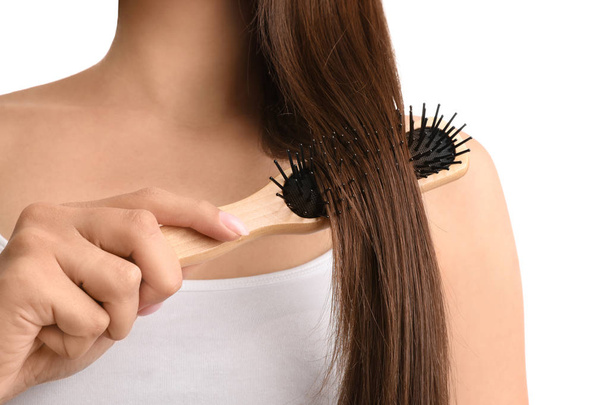 Woman with hair brush on white background, closeup - Foto, immagini