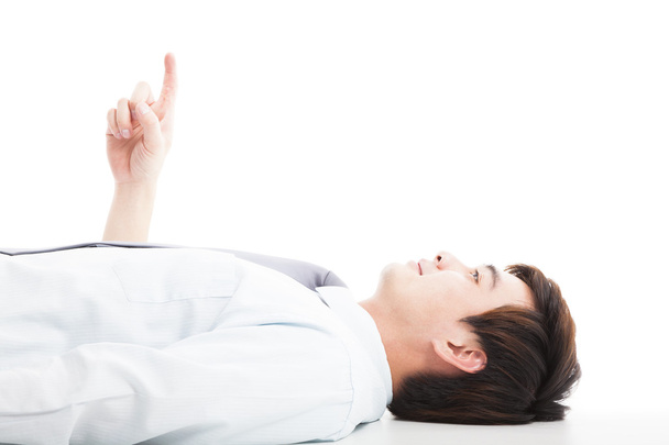 relaxed businessman lie down and pointing up - Foto, Imagen