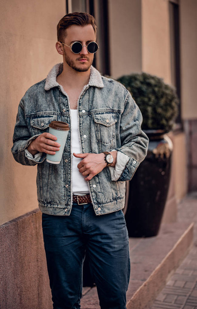 Stylish man with coffee posing on the street  - Fotoğraf, Görsel