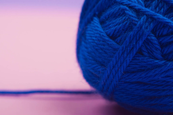 macro photo ball of yarn on pink background. Blue yarn. Close up - Fotó, kép