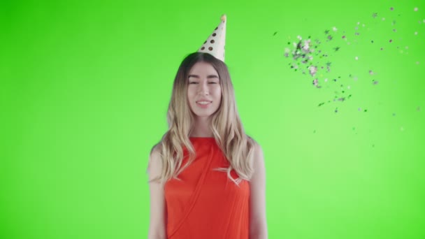 Confetti was thrown at the young girl on a green screen . - Video