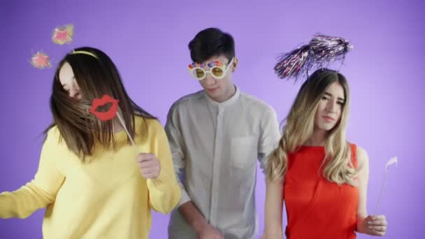 Friends are dancing in a colorful confetti on a purple background. - Filmagem, Vídeo