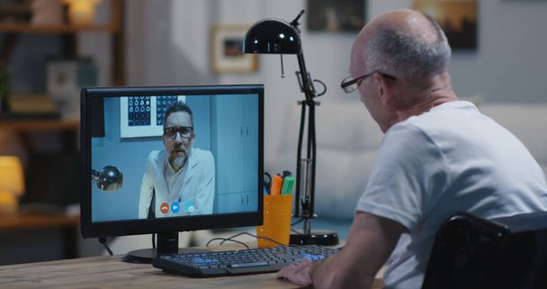 Disabled man video chatting with doctor - Foto, immagini