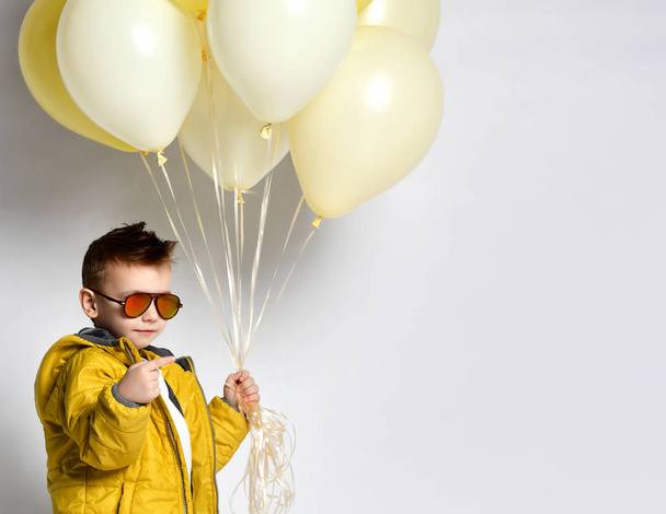 Stylish little boy holding air balloon isolated on white - Valokuva, kuva