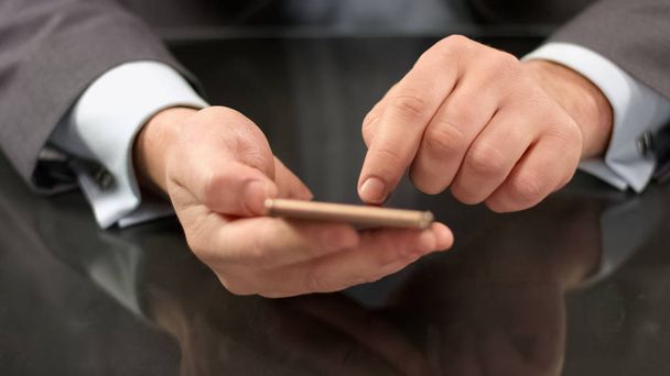 Male boss typing text on smartphone, sending message, business communication - Fotoğraf, Görsel