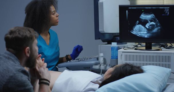 Doctor examining pregnant woman with ultrasound - Photo, Image
