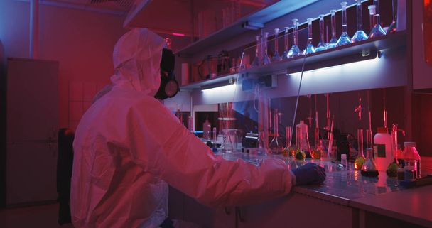 Scientists working in laboratory in red light - Фото, изображение