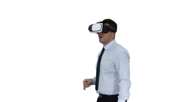 Astonished young businessman wearing VR glasses Concept of the future technology on white background. - Footage, Video