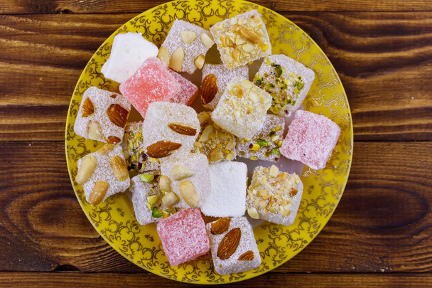 Turkish delight in a plate on wooden table - Photo, Image