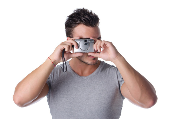 Handsome young man taking photo with compact camera - Zdjęcie, obraz