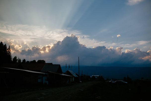 The village at sunset or dawn the sun behind the clouds - Foto, Imagen
