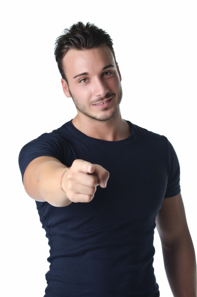 Attractive young man smiling and pointing finger at you - Foto, Bild