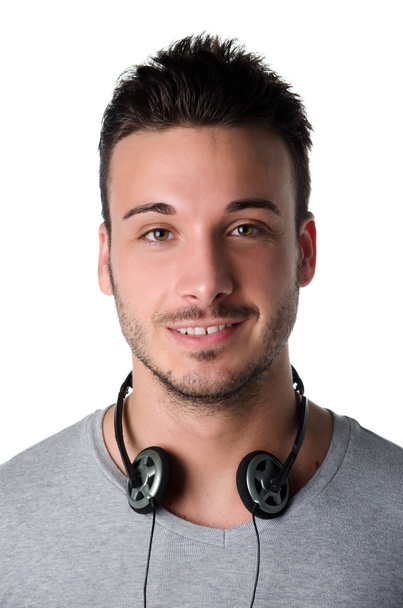 Attractive smiling young man with headphones around his neck - Foto, Imagen