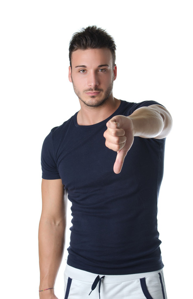 Young man doing thumb down sign - Φωτογραφία, εικόνα