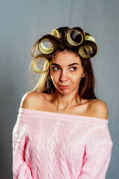 The portrait beautiful girl in hair curlers isolated on grey - Foto, Bild