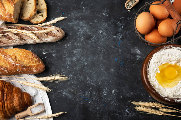 Assortment of fresh bread, baking ingredients. Still life captured from above, banner layout.Healthy homemade bread. Copy space. - Фото, изображение