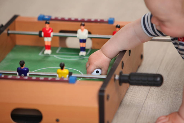 cute liitle boy playing table soccer  - Foto, imagen