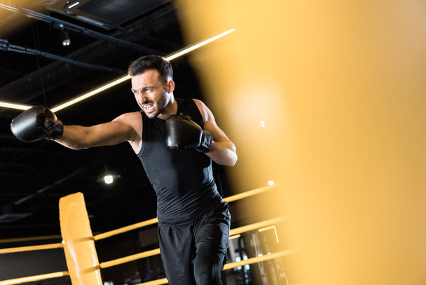 selective focus of athletic bearded man boxing in sports center  - Фото, зображення