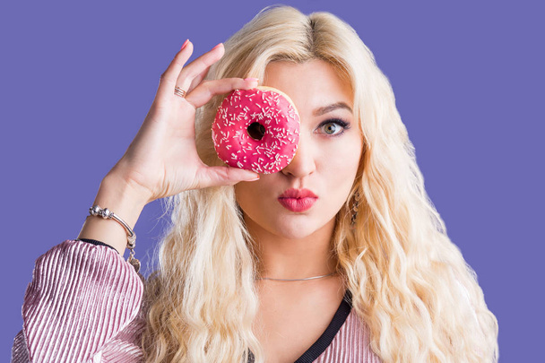 Photo of female holds sweet delicious doughnut - Zdjęcie, obraz